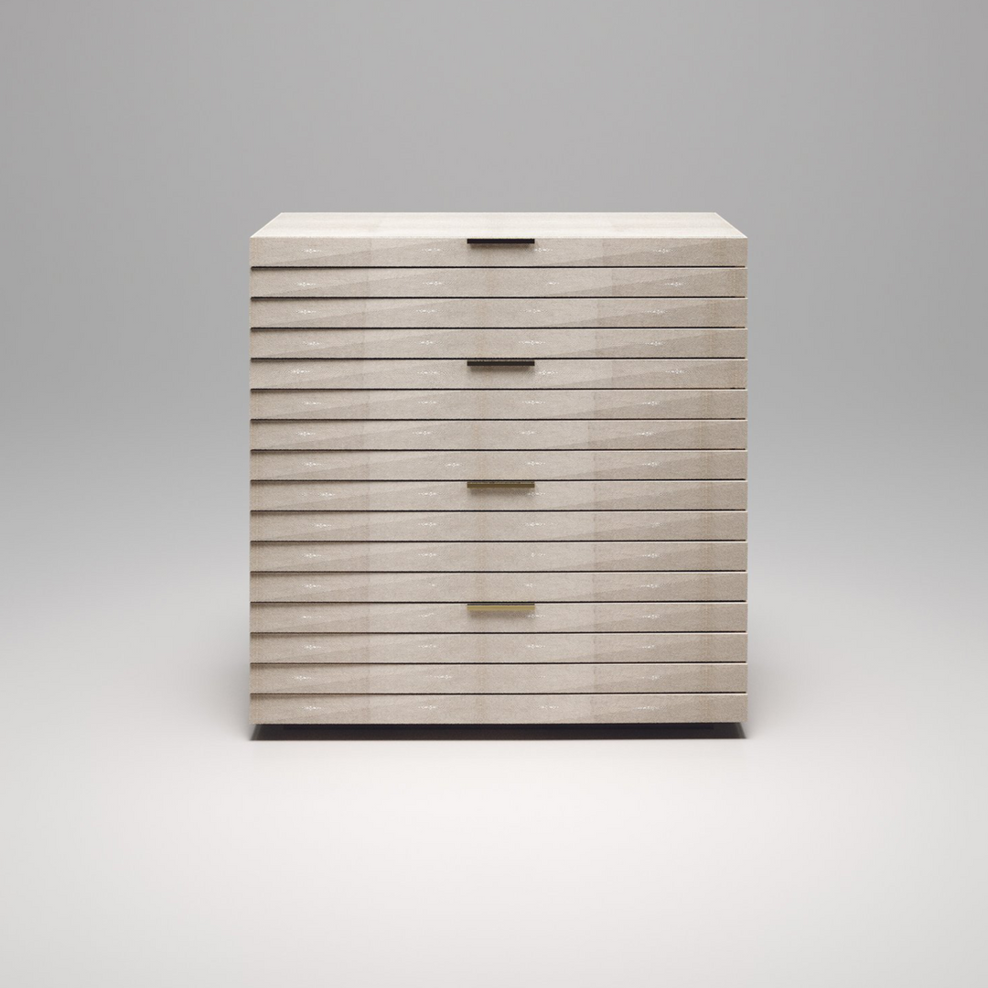 A front view of a chest of drawers with a cream shagreen finish.